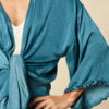 cape in teal with frill sleeves