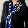 model wearing a pleated scarf with animal print and a blue border