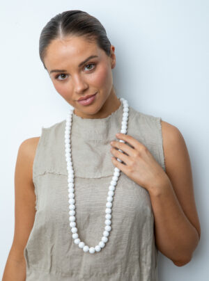 girl wearing a white wooden bead necklace