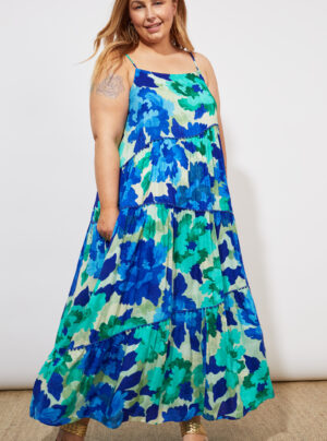 Girl wearing a tiered tank maxi dress in a blue and green print