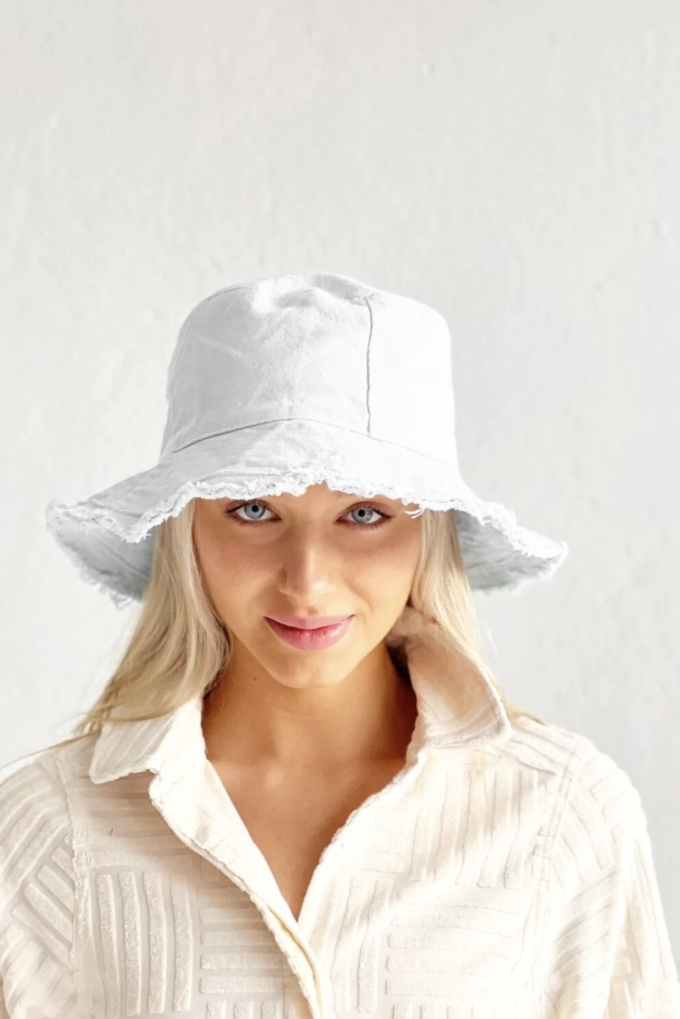 bucket hat in white with a frayed edge